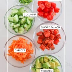 Ingredients for smoked salmon rice bowls in clear glass prep bowls on a white counter.