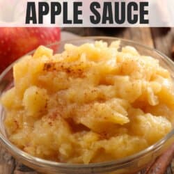 Apple sauce in a white bowl on a wooden table.