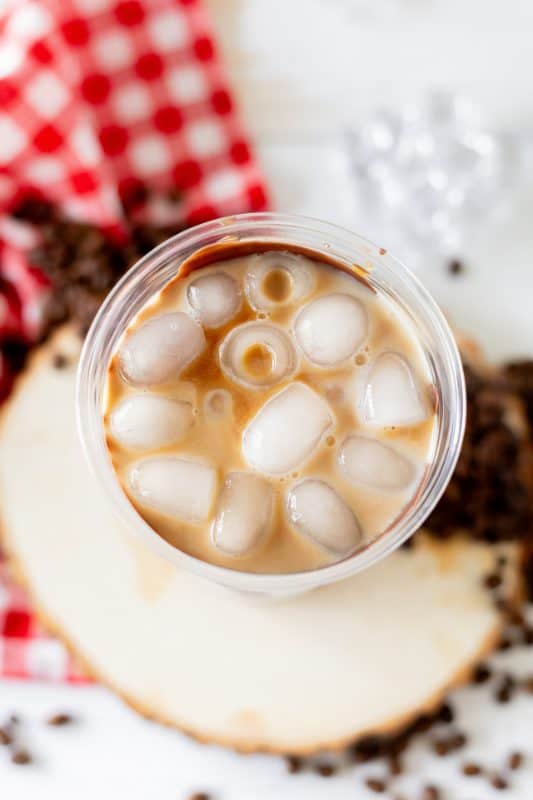 Ice and coffee in a plastic cup.