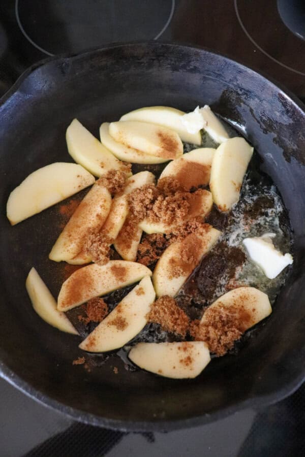 Sliced apples, butter and brown sugar in a cast iron skillet.