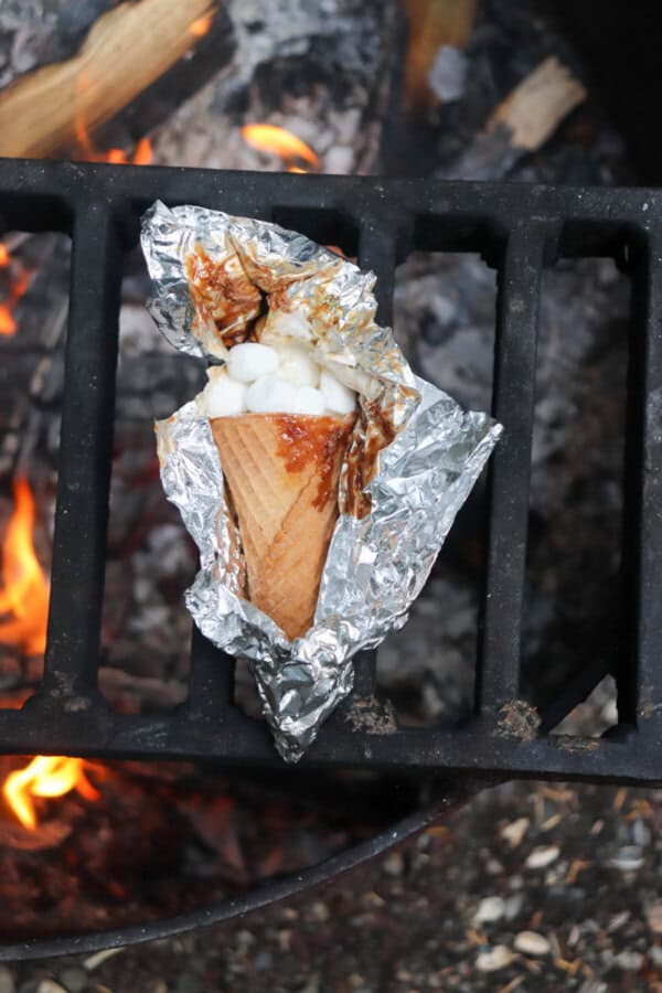 Sugar cone topped with chocolate and marshmallows wrapped in foil.