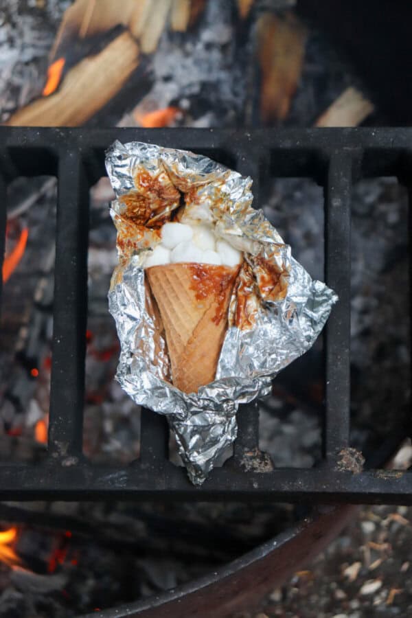 Sugar cone topped with chocolate and marshmallows wrapped in foil.