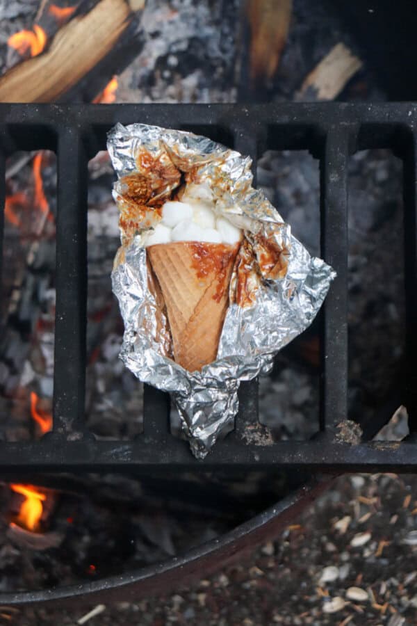 Sugar cone topped with chocolate and marshmallows wrapped in foil.