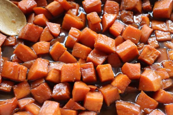 Caramelized cubes of sweet potatoes in a baking dish.