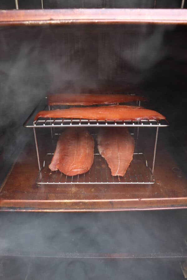 Cold smoked salmon on wire racks in a vertical smoker.