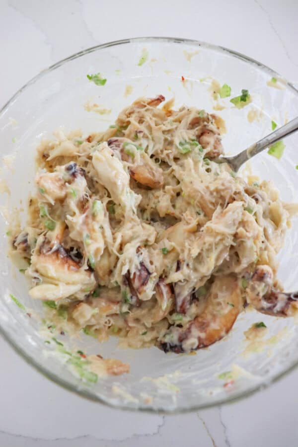 Crab salad mixed in a clear glass bowl.