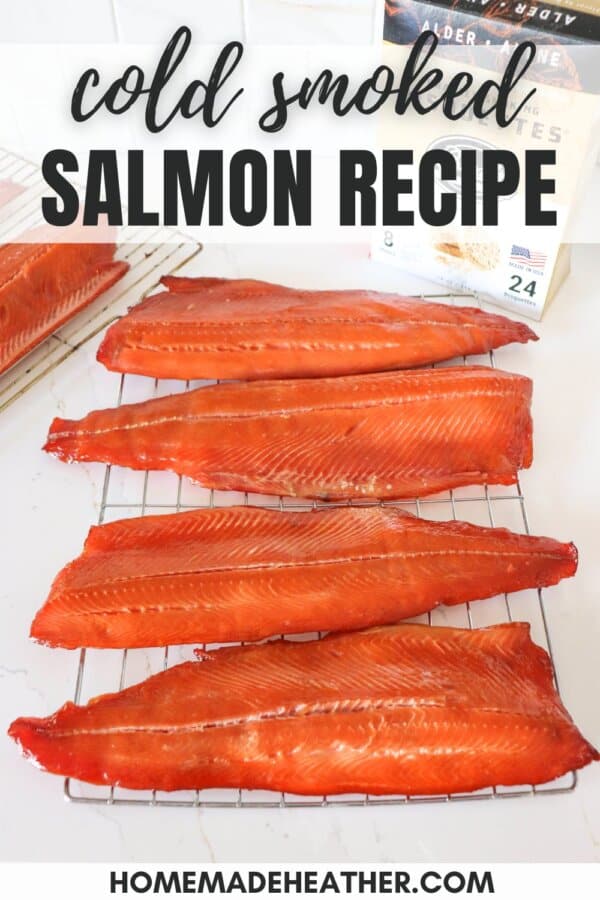 Four cold smoked salmon fillets on a wire rack on a white counter with a box of Bradley Smoker wood pucks in the background.