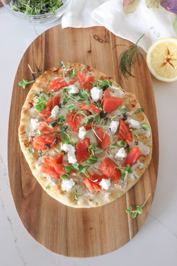 Flatbread topped with cream cheese, smoked salmon, mustard greens and goat cheese.