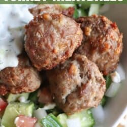 Meatballs in a bed of rice with tzatziki and diced cucumber.