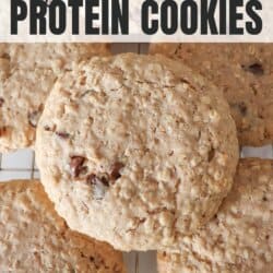 Large oatmeal chocolate chip cookies stacked on one another.