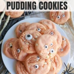 Orange pudding cookies with candy eyes stacked on top of each other.