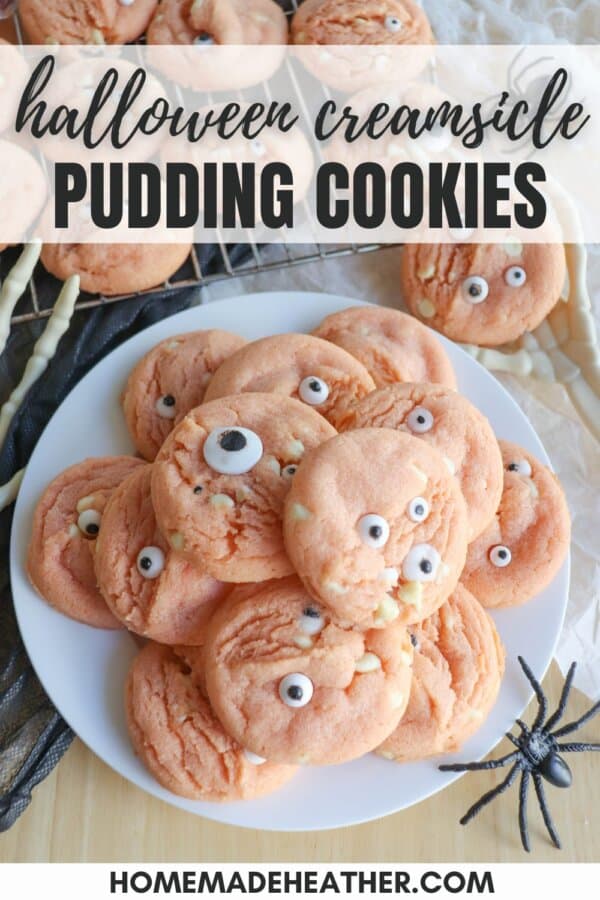 Orange pudding cookies with candy eyes stacked on top of each other.