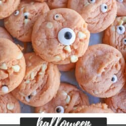 Orange pudding cookies with candy eyes stacked on top of each other.