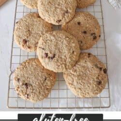 Large oatmeal chocolate chip cookies stacked on one another.