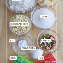 Ingredients for Christmas pudding cookies in clear glass bowls on a wooden table.