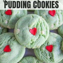 Green pudding cookies with a red candy heart stacked on top of each other.