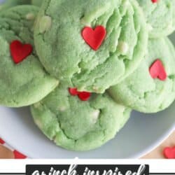Green pudding cookies with a red candy heart stacked on top of each other.