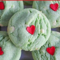 Green pudding cookies with a red candy heart stacked on top of each other.