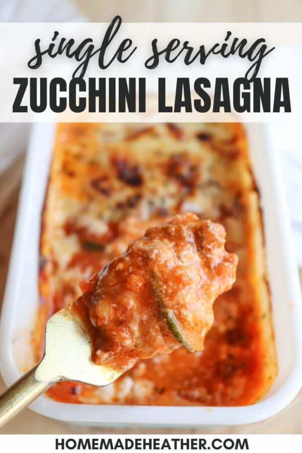 A fork lifts a piece of single serving zucchini lasagna above a baking dish, showcasing layers of zucchini, cheese, and sauce. The image text reads Single Serving Zucchini Lasagna and homemadeheather.com.