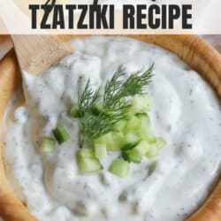 Creamy white tzatziki sauce with diced cucumber and dill garnish.