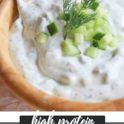 Creamy white tzatziki sauce with diced cucumber and dill garnish.