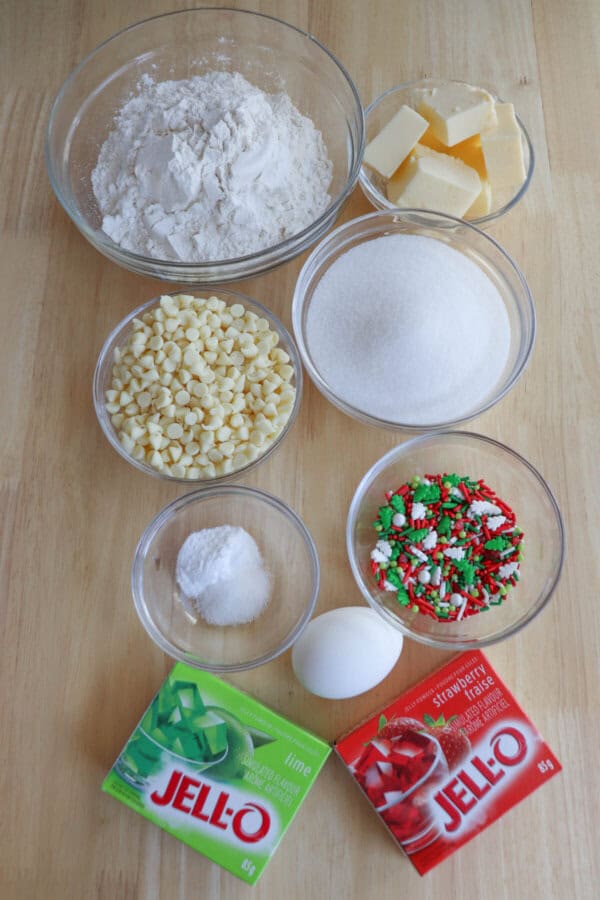Ingredients for Christmas pudding cookies in clear glass bowls on a wooden table.