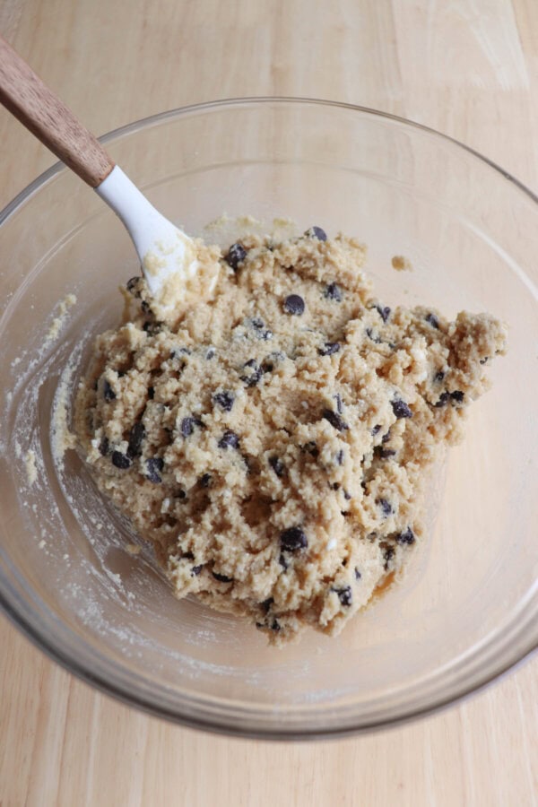 Cottage cheese cookie dough dip in a clear glass mixing bowl.