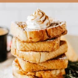 A stack of eggnog French toast topped with whipped cream and cinnamon. The toast is dusted with powdered sugar and displayed on a wooden board. At the bottom, the text reads homemadeheather.com.