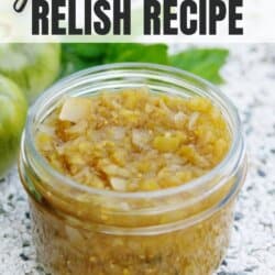 Green tomato relish in a clear glass jar.