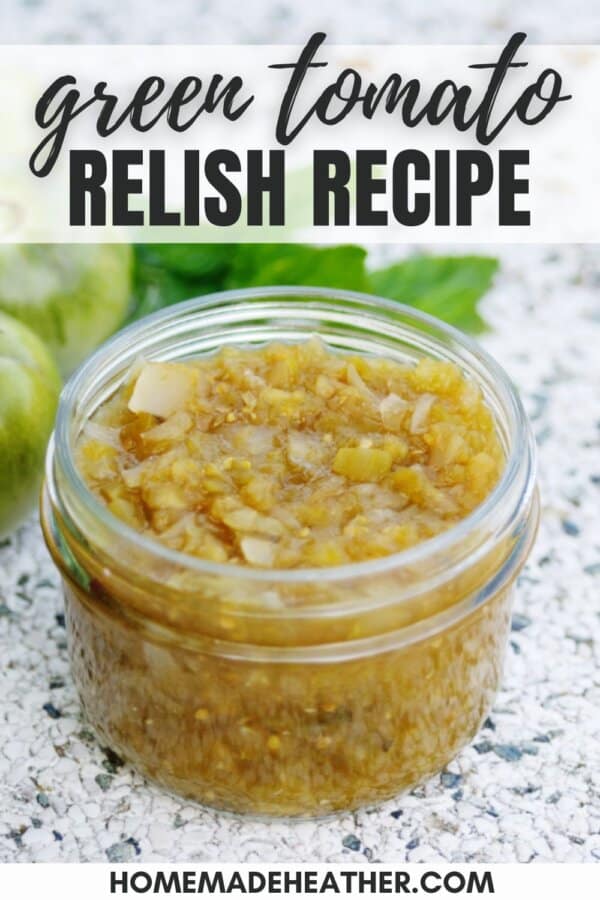 Green tomato relish in a clear glass jar.