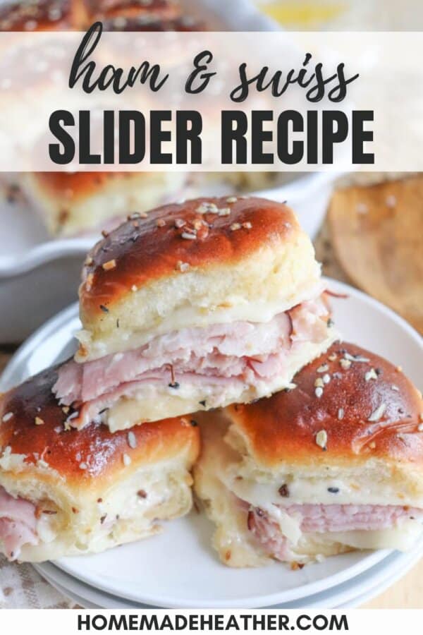 Three Ham & Swiss Sliders stacked on a a white plate.