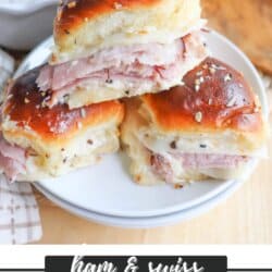 Three Ham & Swiss Sliders stacked on a a white plate.