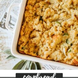 Cornbread stuffing with bread cubes, diced celery and onion bits in a large white casserole dish on a newspaper lined table.
