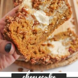 Pumpkin bread, filled with cream cheese with a strussel topping, cut into slices on a wooden board.