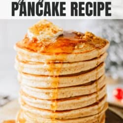 Fluffy gingerbread pancakes stacked on top of each other with a pat of butter on top and syrup dripping over the edges.