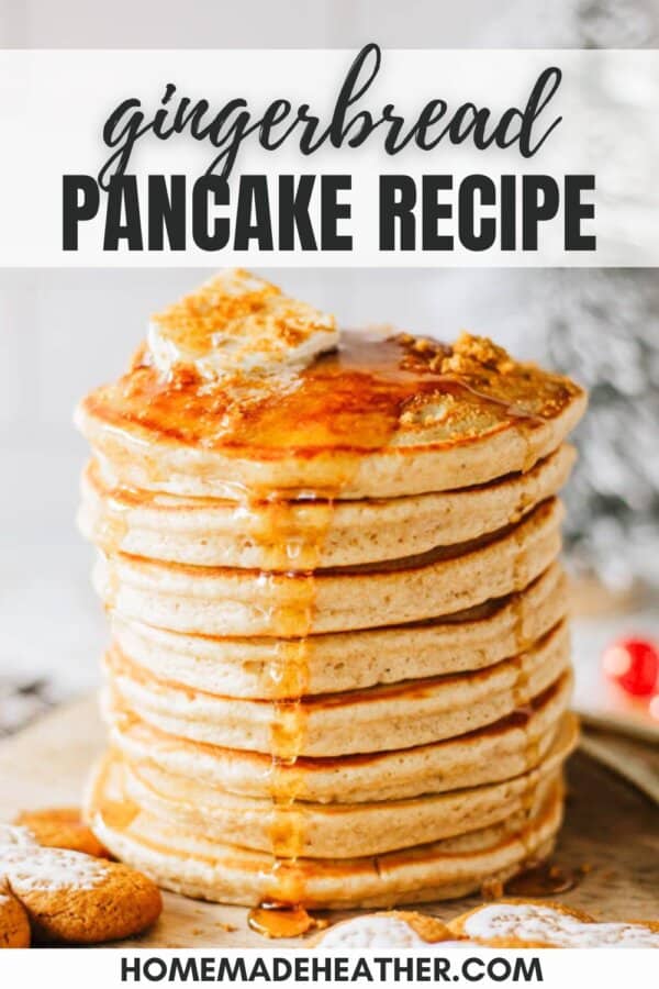 Fluffy gingerbread pancakes stacked on top of each other with a pat of butter on top and syrup dripping over the edges.