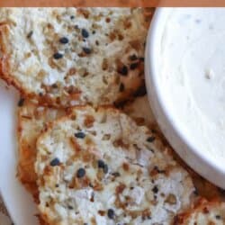 Slices of cottage cheese chips on a white plate, sprinkled with mixed seeds, next to a small bowl of dipping sauce. The overlay text reads cottage cheese chip recipe. Website URL: homemadeheather.com.