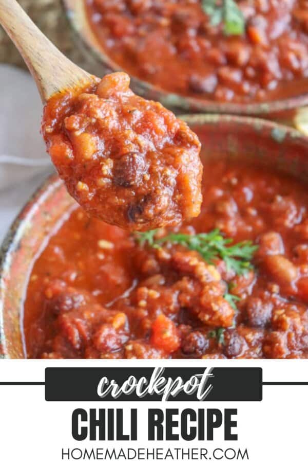 A spoonful of hearty chili with beans and meat held above a bowl. Text reads Crockpot Chili Recipe and homemadeheather.com at the bottom. Garnished with fresh herbs.