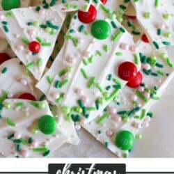 White chocolate bark with white and green sprinkles and red and green m&ms.