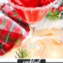 Red drink in a cocktail glass with candy cane garnish and ice.