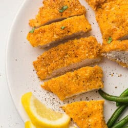 Breaded chicken strips on a white plate.