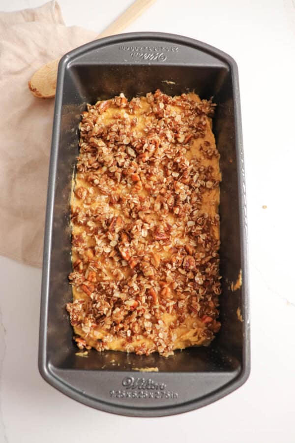 Pumpkin loaf batter topped with brown sugar and pecan streusel.