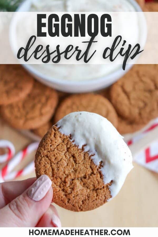 A hand holding a cookie half-covered in white eggnog dessert dip. Below, a plate with more cookies is visible, along with candy canes. Text at the top reads Eggnog dessert dip, and homemadeheather.com is at the bottom.
