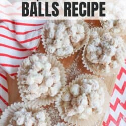 Several snowman-shaped treats covered in powdered sugar are placed in paper cups on a wooden surface. They are surrounded by red and white striped fabric and small red balls. The text above reads Crockpot Snowman Balls Recipe.