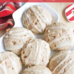 A plate of six eggnog cookies drizzled with icing, set on a festive table with a plaid cloth and red accents. Text on the image reads: Eggnog cookies and homemadeheather.com.