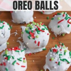 White chocolate-covered Oreo balls topped with red, green, and white sprinkles are arranged on a wooden surface. The text above reads Christmas Oreo Balls and homemadeheather.com.