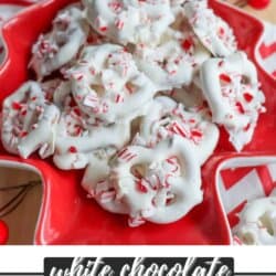 A red star-shaped plate filled with white chocolate-covered pretzels topped with crushed peppermint candy. Red and white striped linens and red ornaments are in the background. The bottom text reads, white chocolate PEPPERMINT PRETZELS.