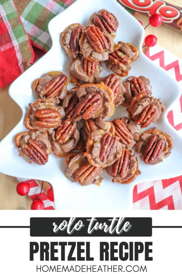 A festive tree-shaped platter holds pretzel snacks topped with melted chocolate, caramel, and pecans. The background features red berries, a plaid cloth, and a candy packaging. Text reads: Rolo Turtle Pretzel Recipe from homemadeheather.com.