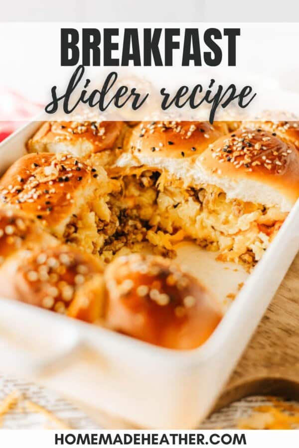 A baking dish filled with breakfast sliders, featuring scrambled eggs, cheese, and sausage, topped with sesame seeds. The text reads BREAKFAST slider recipe and homemadeheather.com is noted at the bottom.