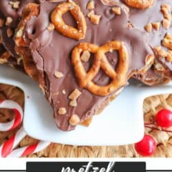 A close-up of chocolate-covered pretzel toffee topped with pretzel pieces. The treats are presented on a white plate with a festive background. Text overlay reads Pretzel Toffee Recipe and homemadeheather.com at the bottom.